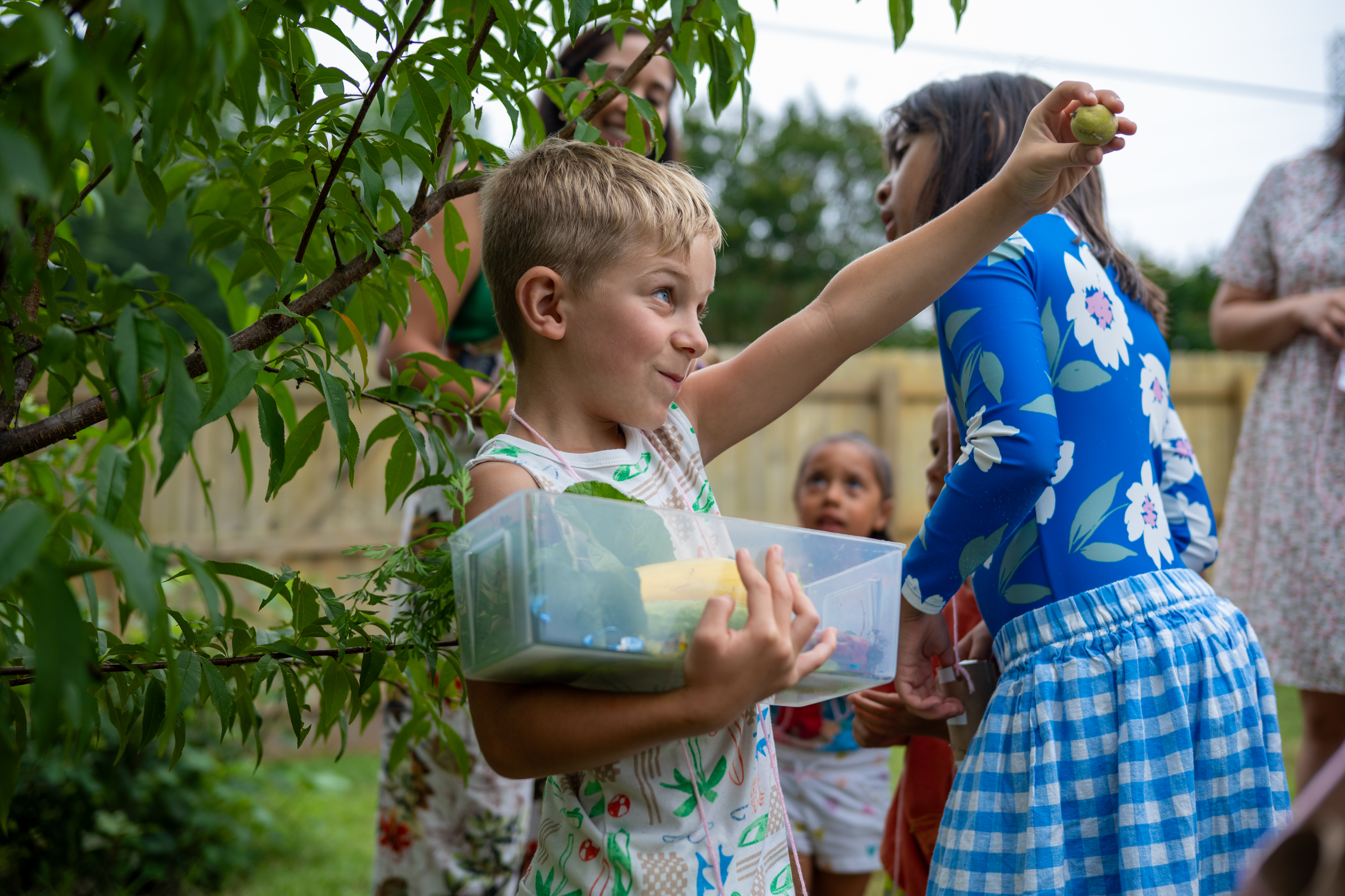 boy showing off fruit